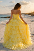 Yellow strapless tiered A-line prom dress with bow